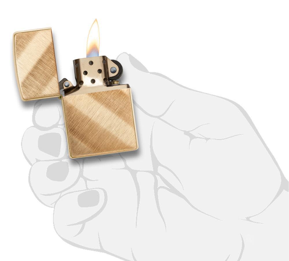 Front view of Diagonal Weave Brass Lighter in hand, open and lit